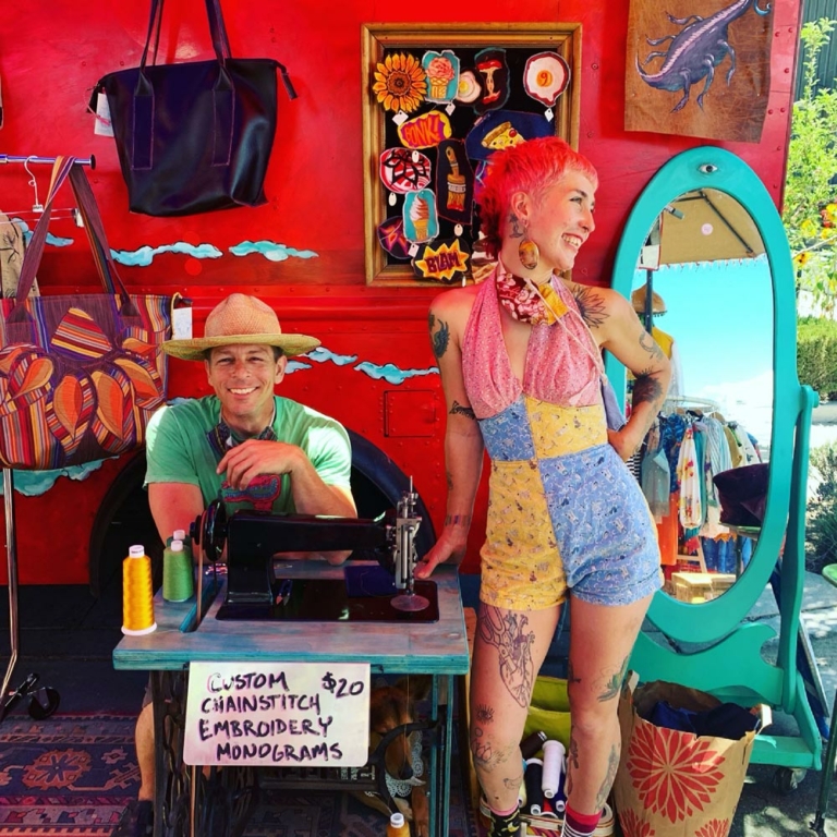 Big Mouth Collective in front of display of their work