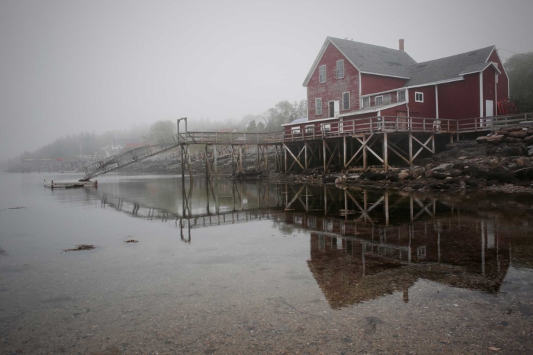art photo of house on shore of still water