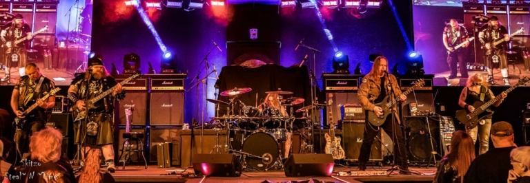 the band on stage, purple lighting