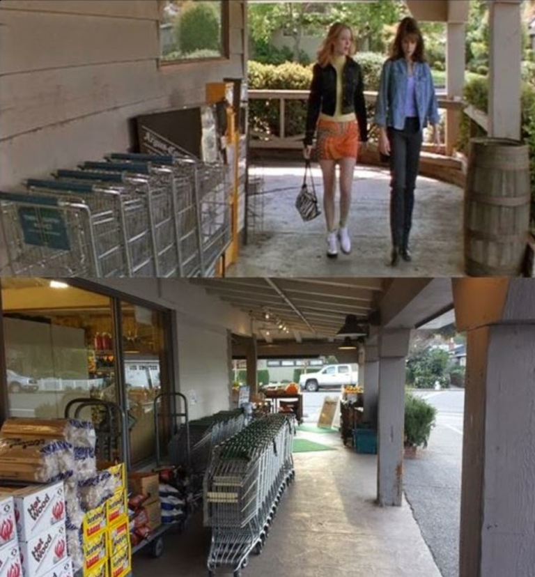 two people walking outside the shop