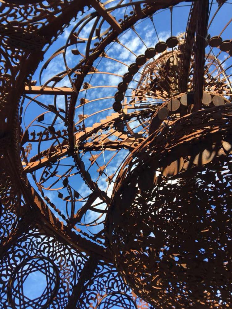 Paradise Ridge look up at sky through rusty metal sculpture