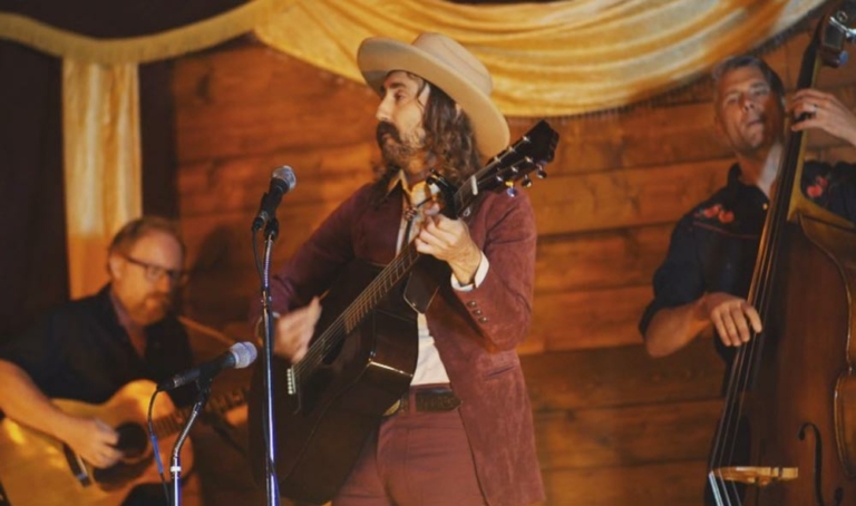 Kevin Carducci playing guitar in front of microphone
