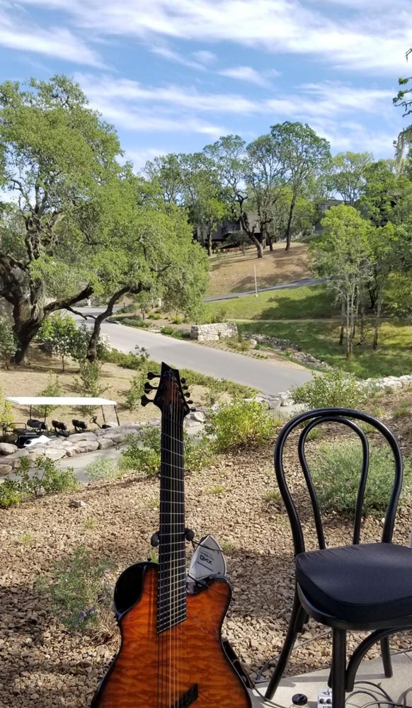 guitar, mask and chair outside