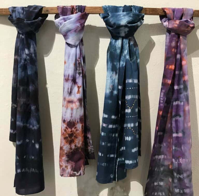 dyed scarves hanging from pole